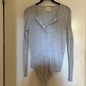 This gray long sleeve ripped bodysuit is super soft worn once.